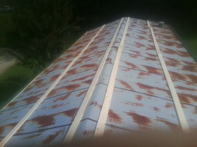 Rusted metal roof panels with new wood purlins before replacement — Storm Damage Roof Repair in Hilton by Roofing Brothers